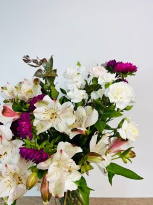 close shot of white alstroemeria and purple everlasting flower arrangement